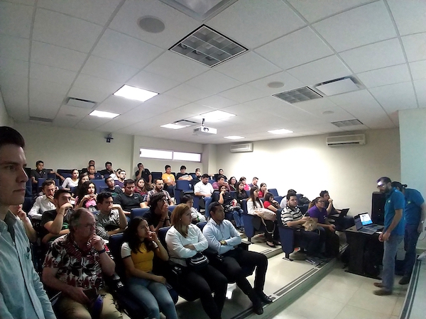 Lecture hall with attendees in seats during Drupal presentation.