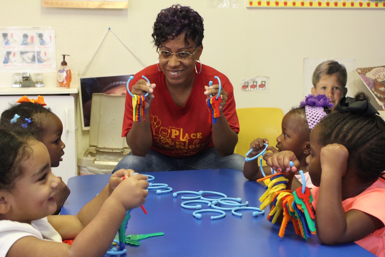 Educator works with preschool age children on learning new skills