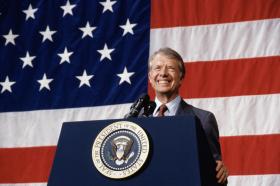 President Jimmy Carter at podium american flag