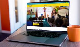 The Dominican University of California homepage displayed on a laptop