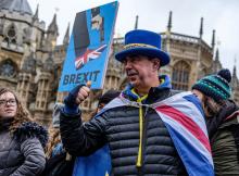 Man holding Brexit sign. Photo by Kevin Grieve on Unsplash